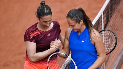 Russia’s Darya Kasatkina, right, shakes hands with France’s Virginie Razzano after winning their women’s second-round match at the French Open. Philippe Lopez / AFP