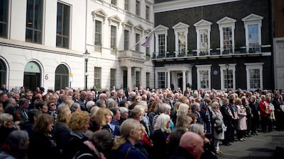 People gather in St James's Square. PA