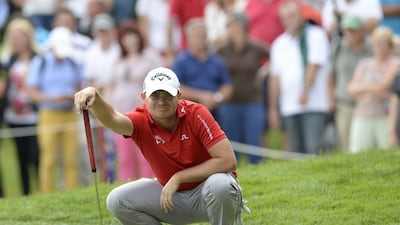 England's James Morrison checks the ground during the third day of the BMW International Open golf tournament in Eichenried near Munich, southern Germany, on June 27, 2015. Morrison leads after the third round. AFP PHOTO / CHRISTOF STACHE