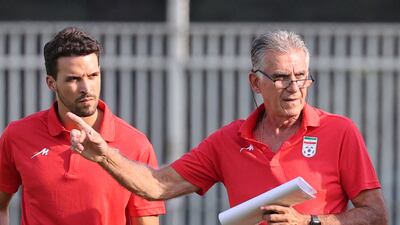 Iran's Portuguese coach Carlos Queiroz (R) speaks to a member of his coaching staff during a training session for the national team at the National team football center in the capital Tehran, on September 14, 2022 . - Carlos Queiroz said he feels "at home" after he returned to Tehran on Wednesday to take charge of Iran for a third successive World Cup finals campaign. The 69-year-old Portuguese coach was appointed to the post last Wednesday having previously been in charge of Iran for eight years, the longest stint in the national team's history. (Photo by ATTA KENARE / AFP)