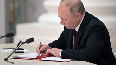 Russian President Vladimir Putin signs documents, including a decree recognising two Russian-backed breakaway regions in eastern Ukraine as independent, during a ceremony at the Kremlin in Moscow. President Vladimir Putin said on February 21, 2022, he would make a decision "today" on recognising the independence of east Ukraine's rebel republics, after Russia's top officials made impassioned speeches in favour of the move. AFP