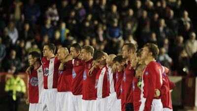 British Army players hold a minute silence prior to their football match against the German Army on Wednesday to commemorate the World War I Christas Day Truce. Lefteris Pitarakis / AP
