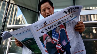 A South Korean man reads a newspaper reporting the U.S. President Trump meeting with North Korean leader Kim Jong-un on June 12, 2018, in Seoul, South Korea. (Photo by Chung Sung-Jun/Getty Images)