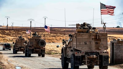 US military armoured vehicles drive in a patrol past an oil well in Rumaylan (Rmeilan) in Syria's northeastern Hasakeh province. AFP