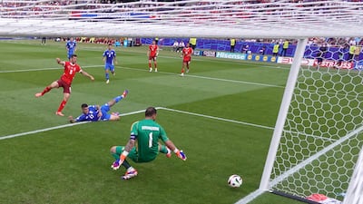 Remo Freuler of Switzerland scores his team's first goal past Gianluigi Donnarumma of Italy. Getty Images