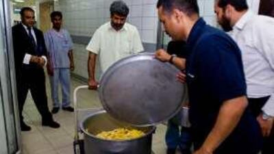 Volunteers collect excess food at Al Boom Tourist Village in Dubai last week.