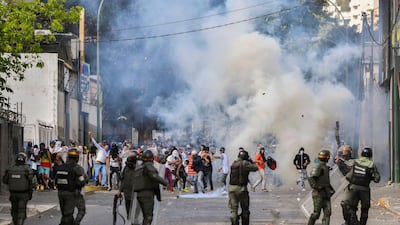 Riot police clash with opposition demonstrators in Caracas. AFP