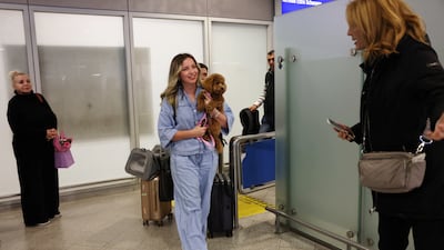 A repatriated Greek and her dog at Eleftherios Venizelos International Airport. Reuters