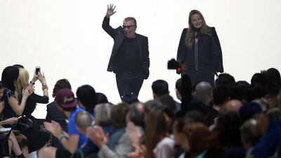 Italian designer Roberto Cavalli greets visitors next to his wife Eva Dueringer after the presentation of his Spring/Summer 2015 collection during Milan Fashion Week. EPA