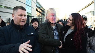 Britain First deputy leader Jayda Fransen is congratulated by a supporter wearing a Donald Trump mask as she leaves Belfast Laganside Courts in Northern Ireland. Charles McQuillan/Getty Images