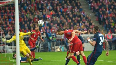 Bayern Munich’s Polish striker Robert Lewandowski, centre, heads the ball to score Bayern’s second goal to make the score 2-2 on aggregate. Guenter Schifmann / AFP