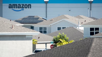 The Amazon logo on one of the e-commerce company's logistics centres in Miami, Florida. The world's largest online marketplace was started by Jeff Bezos from his garage in Bellevue, Washington, US, on July 5, 1994. EPA