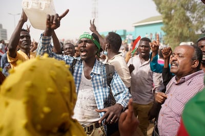 Demonstrators take part in a protest demanding the departure of Sudanese President Omar Al Bashir as they wait for an announcement outside the Sudanese Army headquarters in Khartoum. EPA