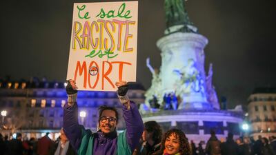 People celebrate the death of far-right politician Jean-Marie Le Pen, at Place de la Republique in Paris. Getty Images