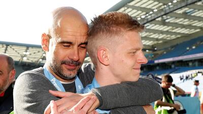 Manchester City manager Pep Guardiola embraces Oleksandr Zinchenko as they celebrate winning the Premier League on Sunday. Getty Images