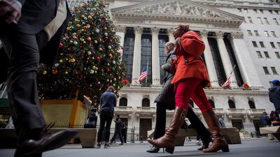 Pedestrians walk past the New York Stock Exchange on Wednesday. The Federal Reserve raised interest rates for the first time in almost a decade in a widely telegraphed move while signalling that the pace of subsequent increases will be "gradual" and in line with previous projections. Michael Nagle / Bloomberg News