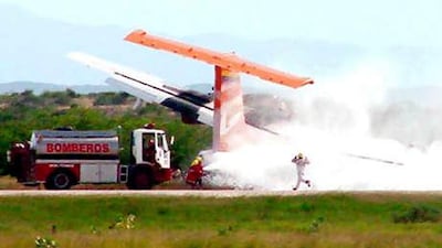 A picture shows rescue workers at the site where an ATR-42 plane crashed in Puerto Ordaz today/