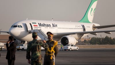 An Iranian Army honour guard stands next to a Mahan Air plane at Mehrabad International Airport in Tehran. NurPhoto via AFP