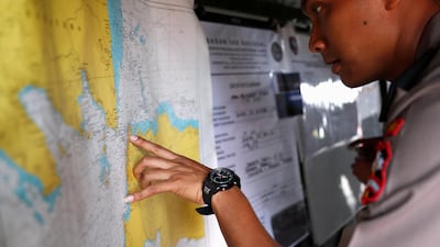 An Indonesian police officer studies a map in the search and rescue command centre at Tanjung Priok port. Reuters