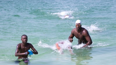 Athletes reach the finish line at the Special Olympics World Games open water swimming competition in La Mer. Reem Mohammed / The National