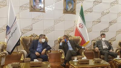 Rafael Grossi, head of the International Atomic Energy Agency, centre, talks to deputy head of the Atomic Energy Organisation of Iran, Behrouz Kamalvandi, left, in Tehran. Mr Grossi will hold talks with Iranian officials as the IAEA considers action against the country. AP