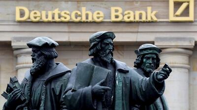 A statue is pictured next to the logo of Germany's Deutsche Bank in Frankfurt. The bank plans to clarify chief executive officer John Cryan’s future on Sunday as pressure from some key shareholders to change leadership mounts. Kai Pfaffenbach / Reuters