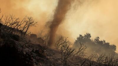 A whirlwind of hot ash and embers moves through a wildfire in the hills of Santa Barbara, California, in 2019. Reuters
