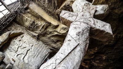 This picture taken shows a view of a relief sculpture made by Polish artist Mario at the St. Simon the Tanner Monastery complex in the Egyptian capital Cairo's eastern hillside Mokattam district, depicting (L, bottom) the attempted seduction of the Old Testament Biblical prophet Joseph by the wife of Potiphar according to the Book of Genesis. Mario spent more than two decades carving the rugged insides of the seven cave churches and chapels of the rock-hewn St. Simon Monastery and church complex atop Cairo's Mokattam hills, with designs inspired by biblical stories. It was all done to fulfil the wishes of the church's parish priest who met Mario in the early 1990s in Cairo. The Polish artist, who had arrived in Egypt earlier on an educational mission, was then looking for an opportunity to serve God at the monastery. AFP