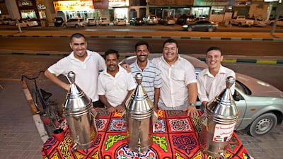 Ajman, August 7, 2011 - From left Haysme Abdo, Mohammed Abdul Safur, Tahir Mahmood, Manager Mohamed Magdi and Mohamed Abdel Hamed outside the Al Koroum Cafeteria where they work. (Jeff Topping/The National)