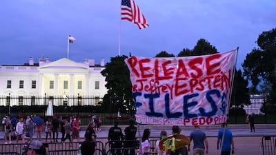 Protesters hold a sign outside the White House on July 18. AFP