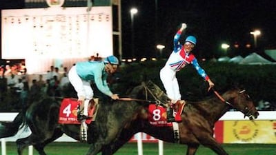 The US jockey Jerry Bailey, riding Cigar, celebrates winning the inaugural Dubai World Cup.