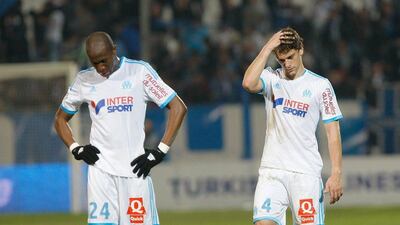 Marseille's Rod Fanni, left and Lucas Mendes react after losing to Nice on Friday night. Claude Paris / AP / March 7, 2014