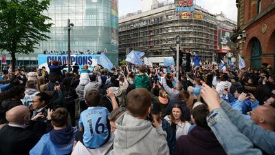 Fans line the streets of Manchester for the open-top bus parade. AP