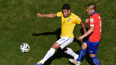Brazil forward Hulk, left, challenges Chile midfielder Francisco Silva during their last-16 World Cup 2014 match on Saturday in Belo Horizonte, Brazil. Francois Xavier Marit / AFP