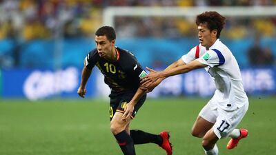 Eden Hazard of Belgium dribbles around Lee Chung-Yong of South Korea in Belgium's final group game on Thursday. Clive Brunskill / Getty Images / June 26, 2014