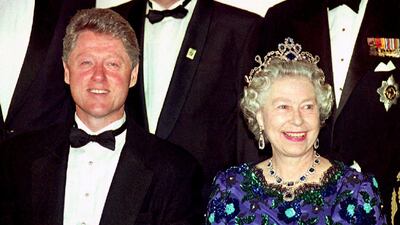 Bill Clinton and Queen Elizabeth smile for the cameras during the group photo session at the Guildhall before a celebratory banquet for the 50th anniversary of D-Day. AFP