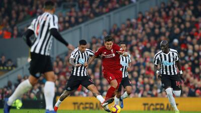 Liverpool's Roberto Firmino in action with Newcastle United's Kenedy and Mohamed Diame. Reuters