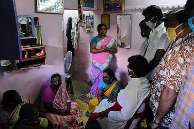 A priest consoles the family P Jayaraj and Bennicks Emmanuel, who died in police custody days after being arrested on June 19, 2020 in India's Tamil Nadu state. AFP