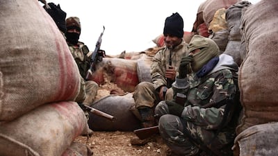 Turkish-backed Syrian opposition fighters gather in a sandbagged barricade near the village of Hamran, near Manbij. AFP