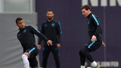 Lionel Messi, right, controls the ball past. Lluis Gene / AFP