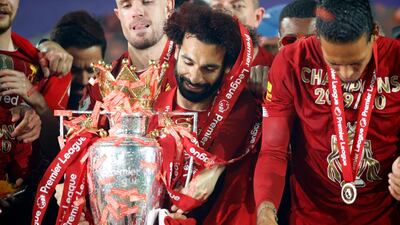 Liverpool's Mohamed Salah with the Premier League trophy after the 2019-20 season. PA