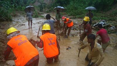 Bangladeshi fire fighters and residents search for bodies after a landslide in the district of Bandarban on June 13, 2017. AFP