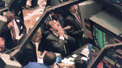A trader on the New York Stock Exchange looks at stock rates on 19 October 1987 as stocks were devastated during one of the most frantic days in the exchange's history. Maria Bastone / AFP