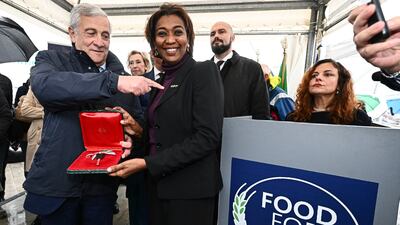 Italian Deputy Prime Minister and Minister of Foreign Affairs and International Co-operation, Antonio Tajani (L) and World Food Programme Deputy Executive Director Rania Dagash (C) at a handover ceremony of the first of 15 trucks donated by Italy to the World Food Programme (WFP) as part of the 'Food for Gaza' initiative, at the port of Genoa, in Italy, on October 25. EPA