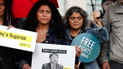 Human rights activists stage a protest outside a court in Istanbul on October 25, 2017. AP Photo / Lefteris Pitarakis