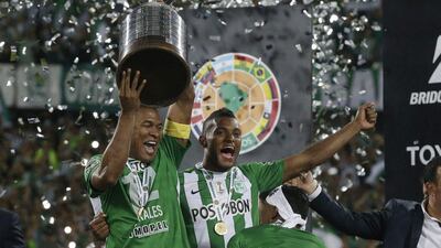 Miguel Borja, right, and Alexis Henriquez of Colombia's Atletico Nacional lift the Copa Libertadores on Wednesday night. Dolores Ochoa / AP Photo / July 27, 2016