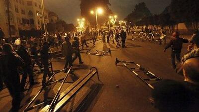 Anti-Morsi protesters barricade a road during clashes with riot police outside the presidential palace in Cairo. The crowd broke through security cordons, as police fired tear gas to contain the situation.