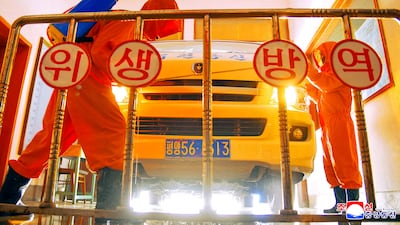 Central Post Office employees disinfect a vehicle as part of efforts to slow the spread of Covid-19 in Pyongyang, North Korea. Reuters