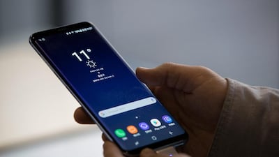 A visitor tries out a Samsung Electronics Galaxy S8 smartphone. SeongJoon Cho / Bloomberg