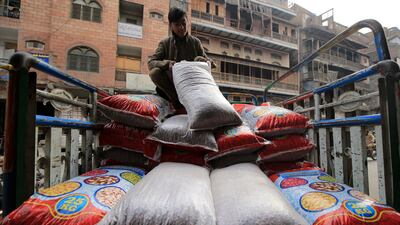A worker offloads supplies at a shop in Peshawar. Price gains in Pakistan quickened for a third month in February. EPA